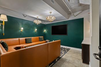 Home theater room with teal walls and leather seating